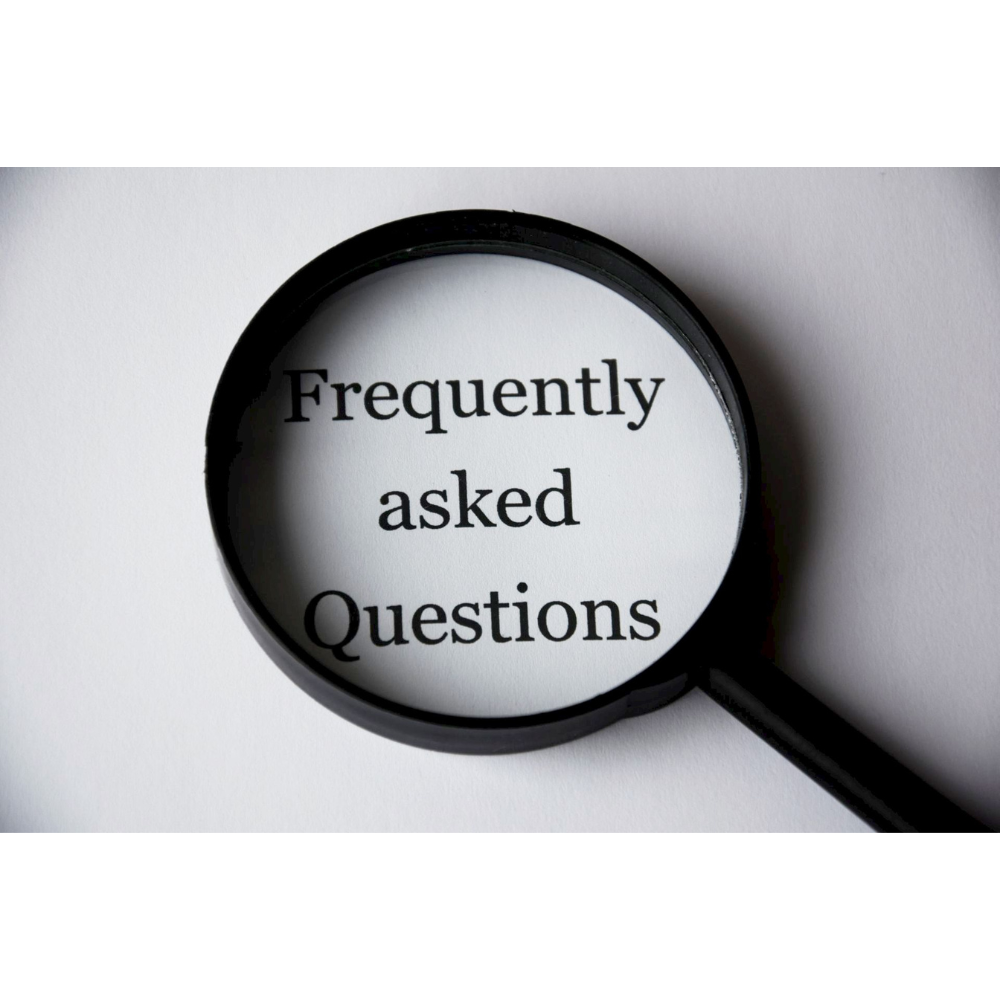 magnifying glass over the text "Frequently asked Questions" demonstrating the importance of informative content for a law firm website