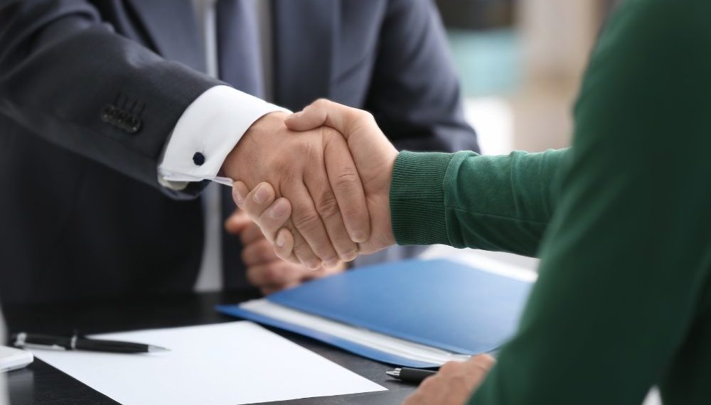 Lawyer Client Acquisition - lawyer shaking hands with a new client