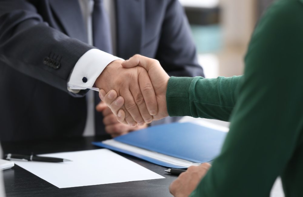 Lawyer Client Acquisition - lawyer shaking hands with a new client